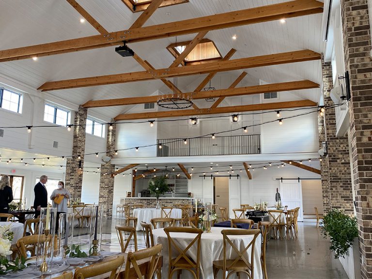 Wedding lights professionally installed by the Texas Light Crew. The lights are stung across the room and accent the wood beams and high ceiling in the banquet room