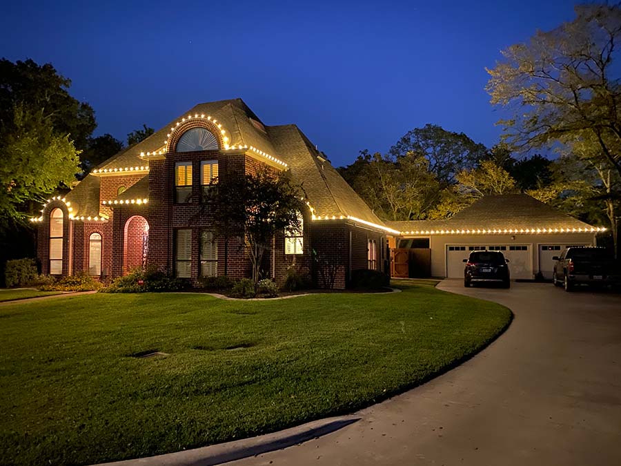 Outdoor Christmas lights installed in Cedar Park TX on a two story brick house.
