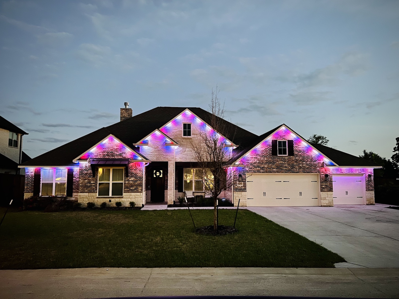 Color changing, permanent Christmas lights installed under the roof line on the front of a house