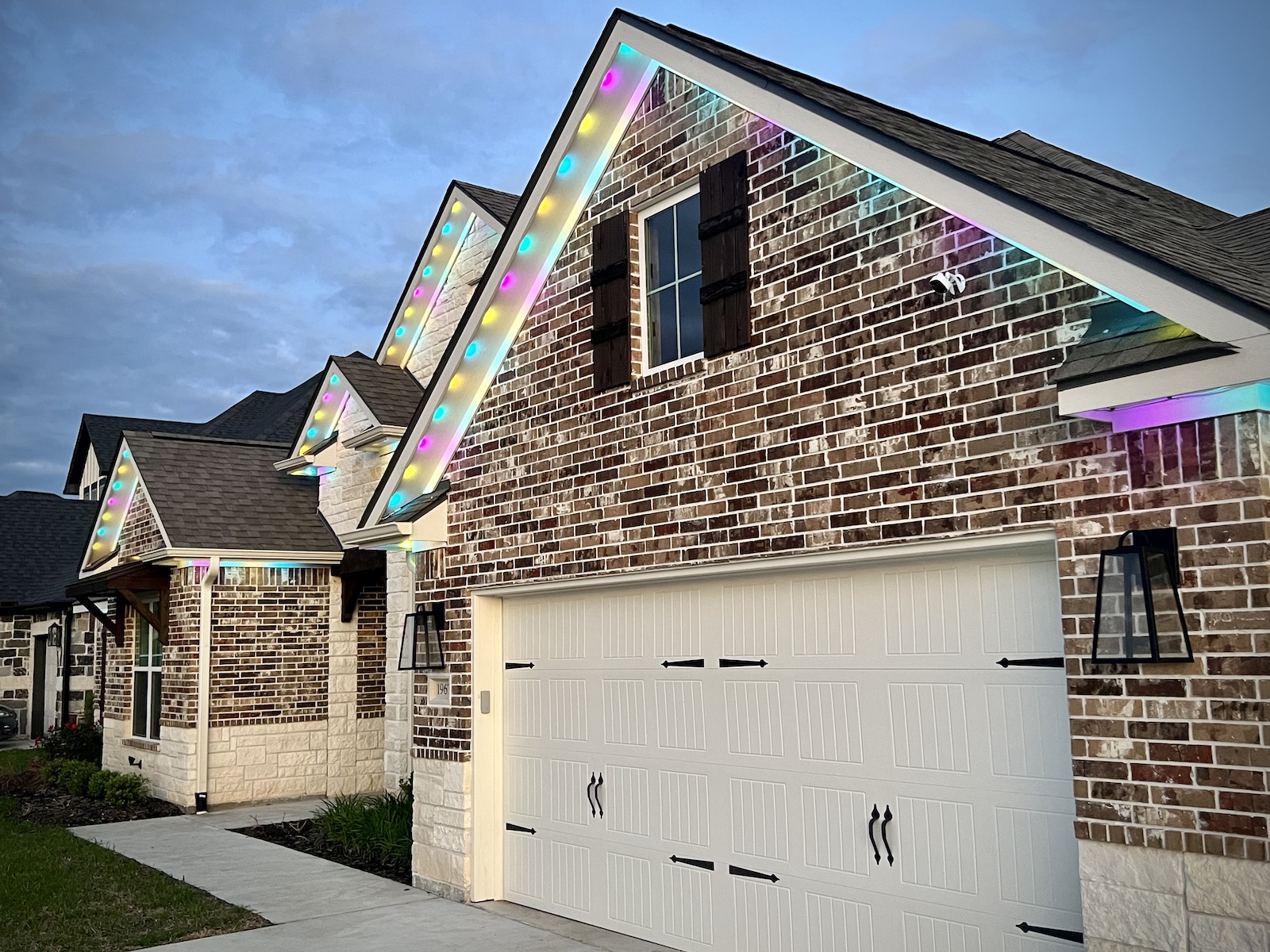 Color changing, permanent Christmas lights installed under the roof line on the front of a house