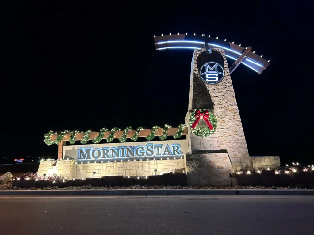 Morningstar limestone entry monument with Christmas wreaths and lights